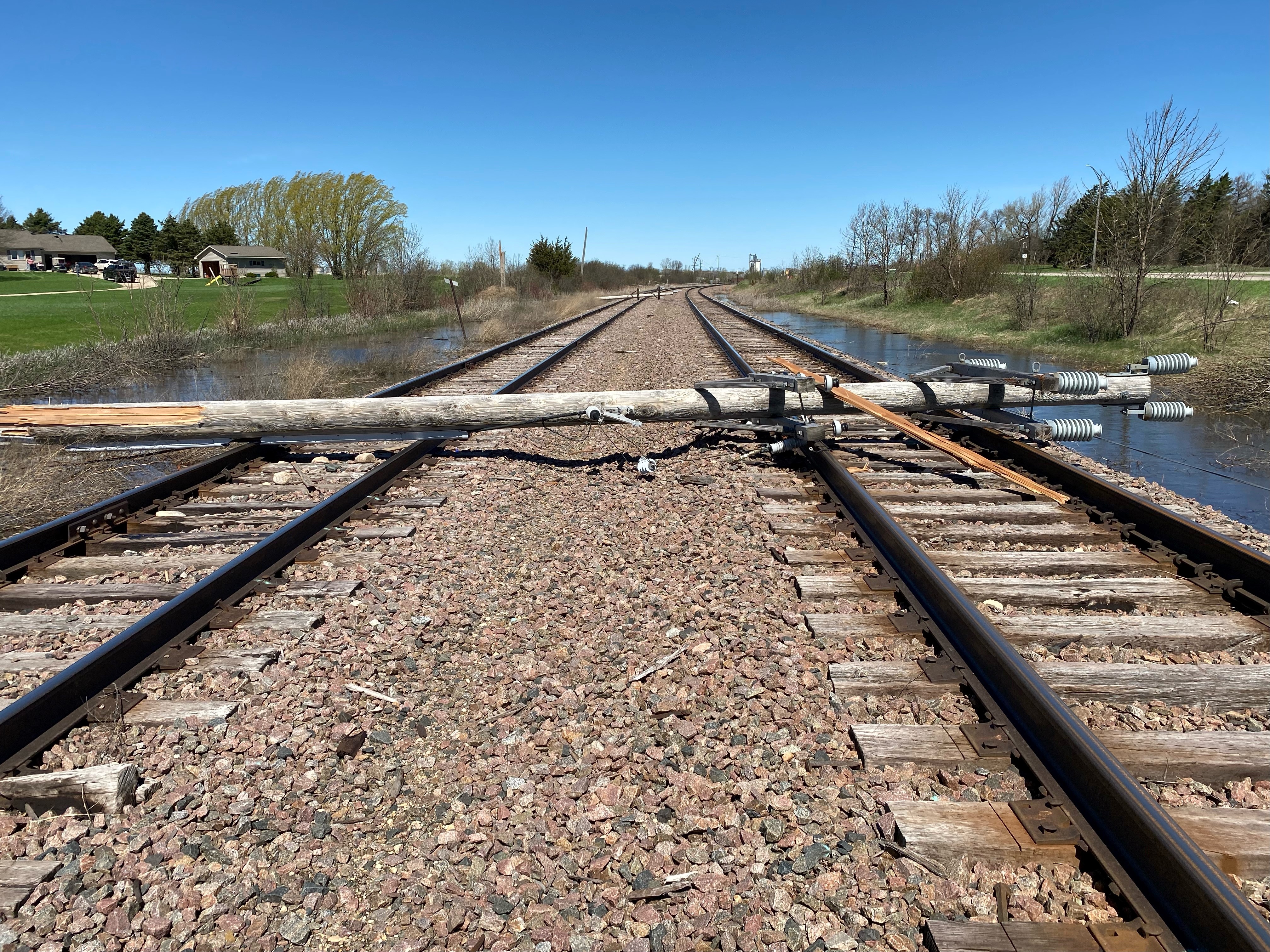 A power pole and line lays over railroad tracks in Morris, Minnesota.