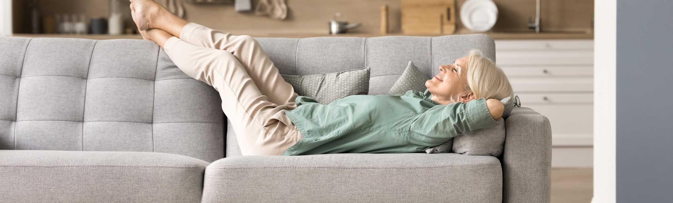 Woman relaxing on sofa at home